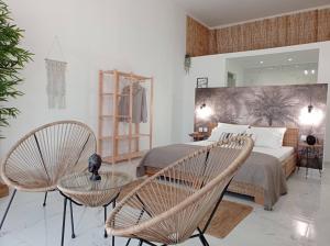 a bedroom with a bed and two chairs at Maistrali in Provatas