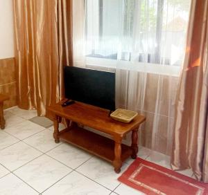 a television sitting on a table in front of a window at Costa Calma Apartment OASIS in Costa Calma