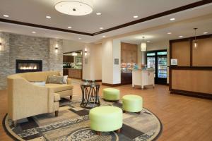 uma sala de estar com um sofá e cadeiras e uma lareira em Homewood Suites by Hilton Kalamazoo-Portage em Kalamazoo