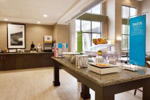 a large kitchen with a counter in a room at Hampton Inn & Suites Birmingham Airport Area in Birmingham