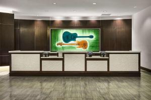 a reception desk with a painting of a guitar at Hilton Garden Inn Nashville Downtown/Convention Center in Nashville