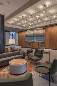 un vestíbulo con sofás, sillas y una mesa en Hilton Boston-Woburn, en Woburn