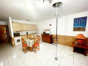 a kitchen and dining room with a table and chairs at Costa Calma Apartment OASIS in Costa Calma