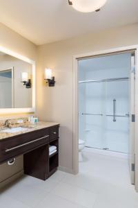 uma casa de banho com um chuveiro, um lavatório e um WC. em Homewood Suites by Hilton Akron/Fairlawn em Akron