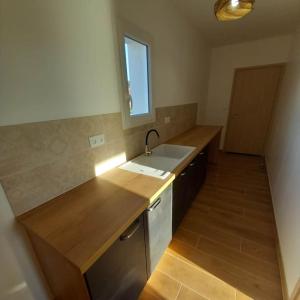 a kitchen with a sink and a counter top at Gîte pour 8 personnes in Frespech