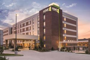 a hotel with a sign on the front of a building at Home2 Suites by Hilton College Station in College Station