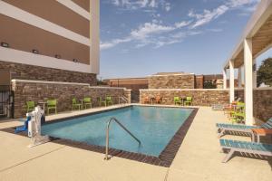 a swimming pool on the roof of a building at Home2 Suites by Hilton College Station in College Station