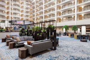 a lobby of a hotel with couches and tables at Embassy Suites by Hilton Columbus Dublin in Dublin