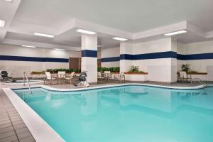 a pool in a hotel room with blue water at Embassy Suites by Hilton Columbus Dublin in Dublin