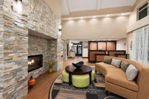 a living room with a couch and a fireplace at Homewood Suites by Hilton Columbus-Hilliard in Hilliard