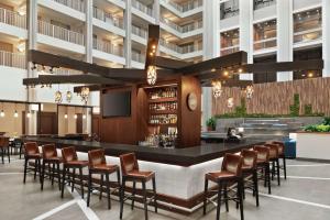 a rendering of the lobby of a hotel with a bar at Embassy Suites Cincinnati - RiverCenter in Covington