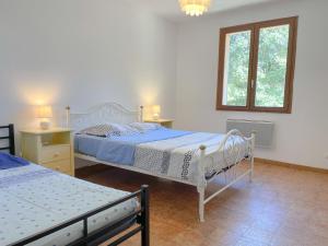 a bedroom with two beds and a window at Valansolette in Beynes