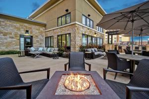 un patio con mesas, sillas y una hoguera en Homewood Suites by Hilton Dallas Arlington South en Arlington