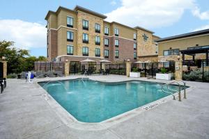 a large swimming pool in front of a building at Homewood Suites by Hilton Dallas Arlington South in Arlington