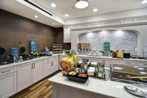 a large kitchen with white cabinets and a counter top at Homewood Suites by Hilton Dallas Arlington South in Arlington