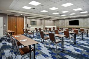 a conference room with tables and chairs and a tv at Homewood Suites by Hilton Dallas Arlington South in Arlington