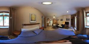 a bedroom with a large bed with blue sheets at Bruno in Bale