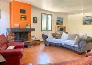 a living room with a couch and a fireplace at Valansolette in Beynes