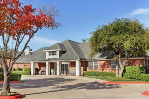 a brick house with a gray roof at Homewood Suites Dallas-Addison in Addison