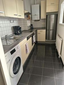 a kitchen with a washing machine and a sink at Ferienwohnung Südstrand in Wilhelmshaven