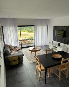 a living room with a table and a couch at FURNAS DREAM HOUSE in Furnas