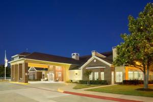 a large building with a driveway in front of it at Homewood Suites by Hilton Dallas-Park Central Area in Dallas