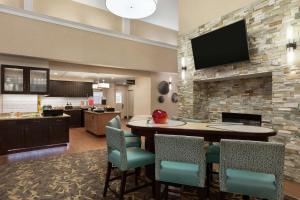 a kitchen and dining room with a table and chairs at Homewood Suites by Hilton Dallas-Park Central Area in Dallas