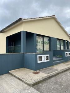 a blue and white building with a lot of windows at FURNAS DREAM HOUSE in Furnas