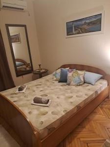 a large bed in a bedroom with a mirror at Apartmani Pandurevic in Herceg-Novi