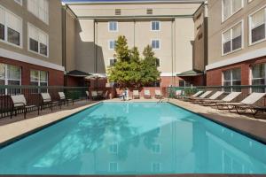 a large swimming pool with chairs and a building at Homewood Suites by Hilton Dallas-Plano in Plano