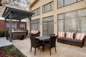 a patio with a table and chairs and a couch at Homewood Suites by Hilton Dallas-Plano in Plano
