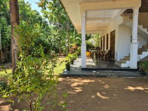 a front porch of a house with a table at Thuruliya Residence in Sigiriya