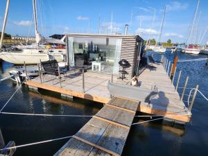 a small boat is docked at a dock at Houseboat of Grimm in Fehmarn