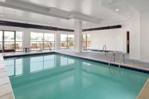 a swimming pool with blue water in a building at Hampton Inn & Suites Denver-Cherry Creek in Denver