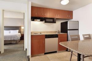 a kitchen and dining room with a bed in a hotel room at Hampton Inn & Suites Denver-Cherry Creek in Denver