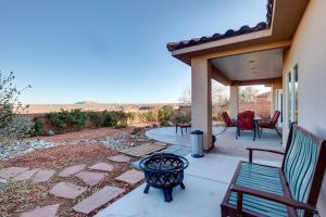a patio with benches and a table and chairs at Horseshoe Bend Retreat with Fire Pit and Mtn Views in Page