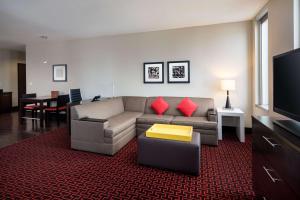 a living room with a couch and a television at Homewood Suites- Denver Downtown Convention Center in Denver