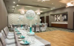 a room with a long table with white chairs at Homewood Suites- Denver Downtown Convention Center in Denver