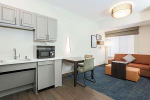 a kitchen and living room in a hotel room at Hampton Inn & Suites Denver Tech Center in Centennial