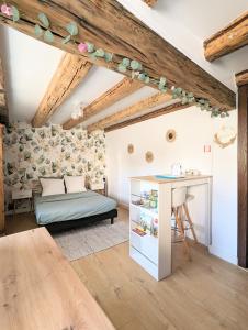 ein Wohnzimmer mit einem Bett und einem Tisch in der Unterkunft Le nid d'hirondelle in Gertwiller