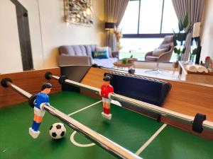 two lego men playing a game of soccer in a living room at Loft Suite Seaview Near Johor Bahru Custom 7 pax in Johor Bahru