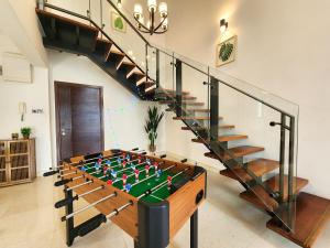 a large foosball table in a room with a staircase at Loft Suite Seaview Near Johor Bahru Custom 7 pax in Johor Bahru