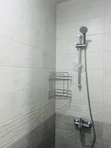 a shower with a shower head in a bathroom at Apartment in Orbi Beach Tower in Batumi