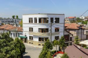 a white building with red roofs in a city at Villa Casafina Serviced Apartments in Mangalia