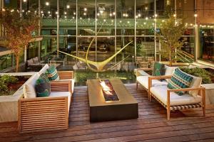 a patio with couches and a fire pit on a building at The Statler Dallas, Curio Collection By Hilton in Dallas