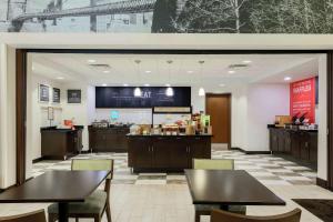 a restaurant with tables and chairs and a counter at Hampton Inn & Suites Wheeling - The Highlands in Triadelphia