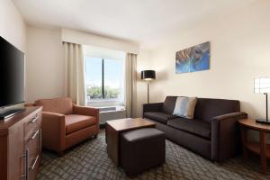 a living room with a couch and a chair at Homewood Suites by Hilton Houston NW at Beltway 8 in Houston