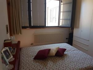 a bedroom with a bed with two pillows on it at Romantic loft in Venezia in Venice