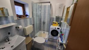 a small bathroom with a toilet and a sink at Planinska kuća Rezo Rakitno in Posušje +24 photos