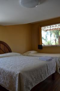 a bedroom with two beds and a window at La Casona Recoleta in Arequipa